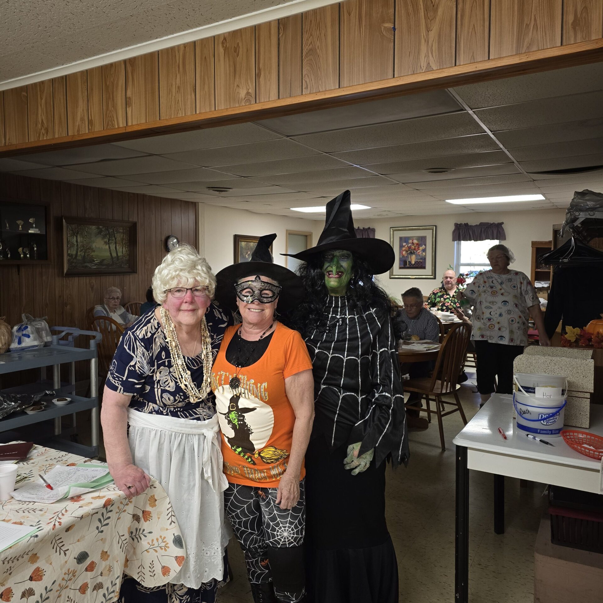 Three volunteers in costume at the Breen Senior Center Halloween meal
